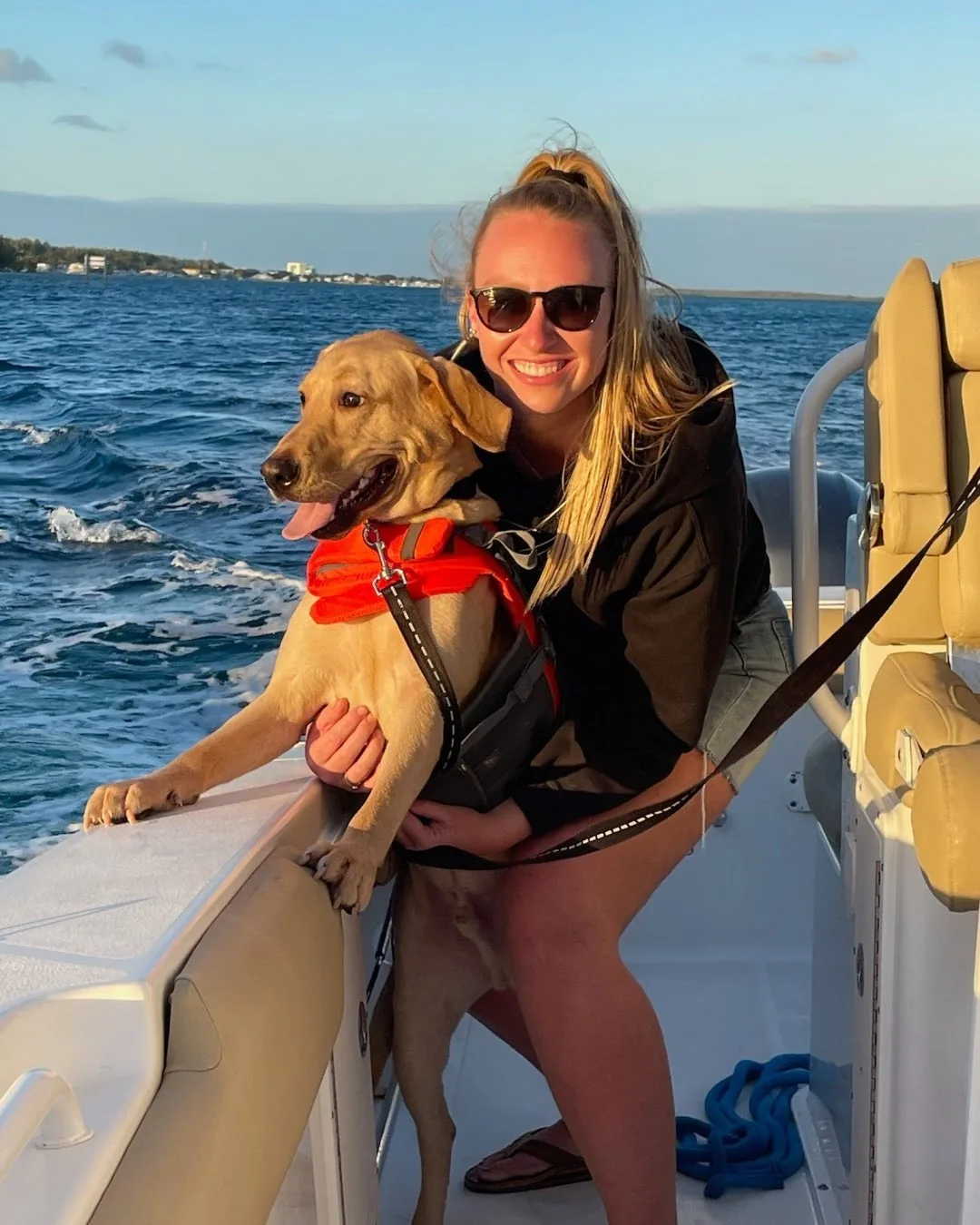 A guest and her dog aboard a Bimini Blue Adventures charter